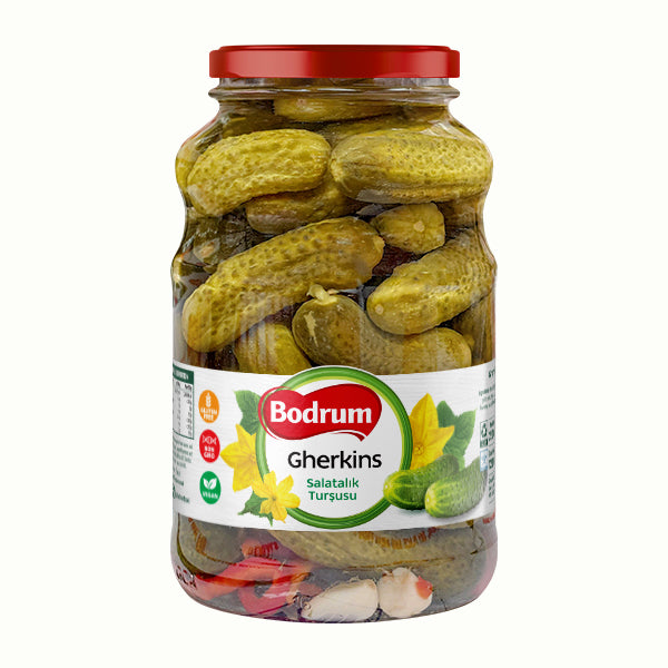 Jar of Bodrum gherkins with a red lid on a white background