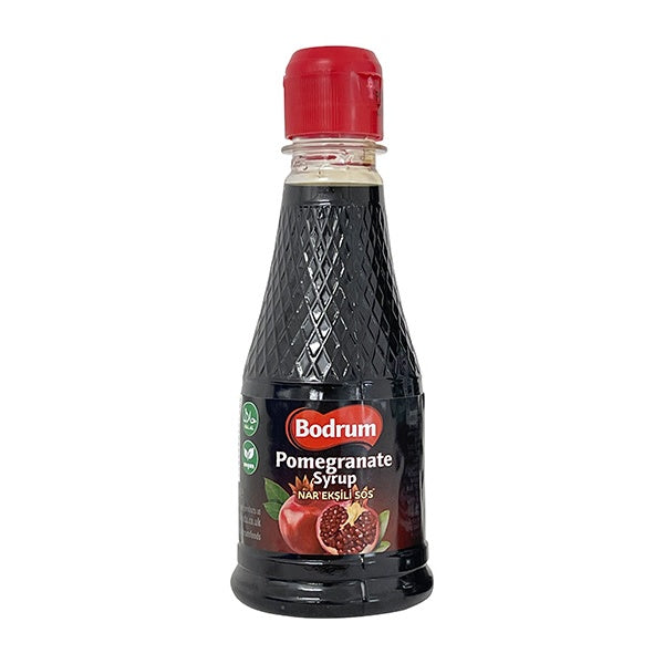 Bottle of Bodrum Pomegranate Syrup with a red cap on a white background