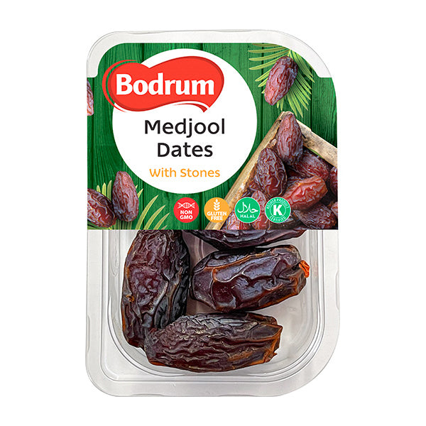 Packaged Medjool dates with stones on a white background