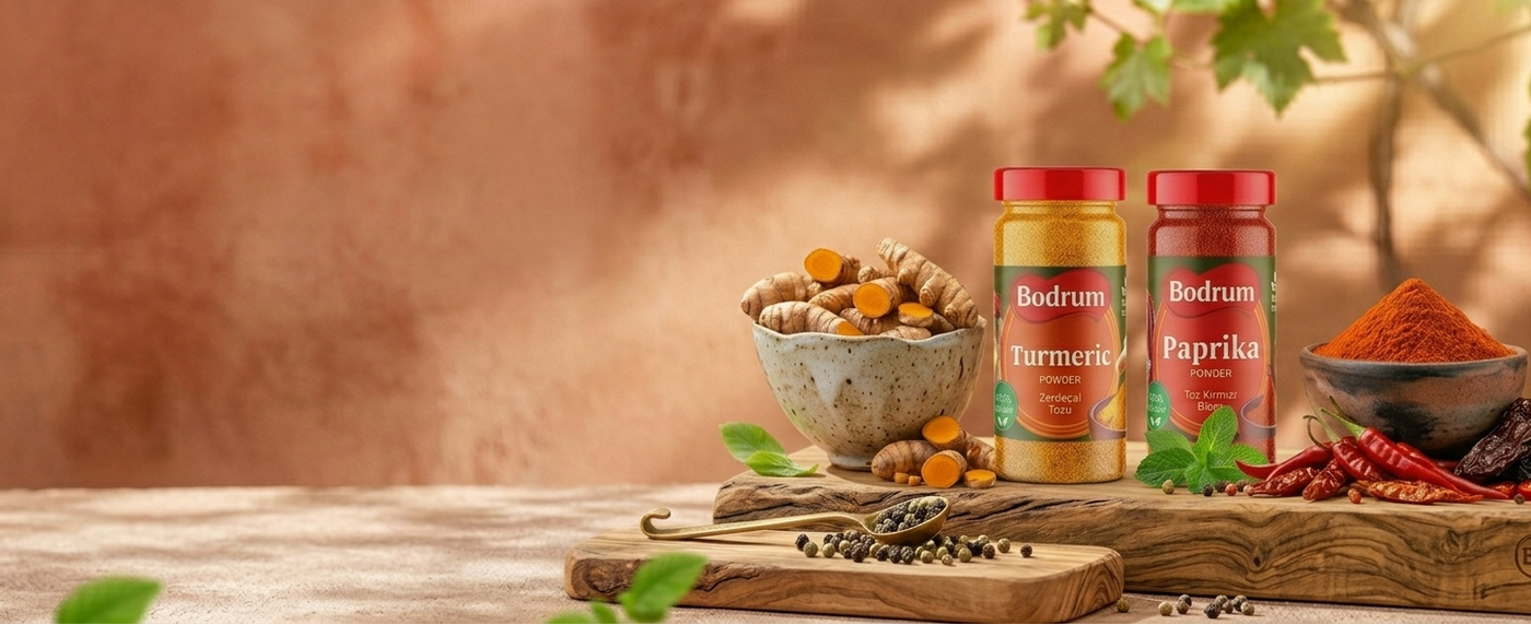 Two bottles of Bodum coffee and tea with spices and fruits on a wooden table.