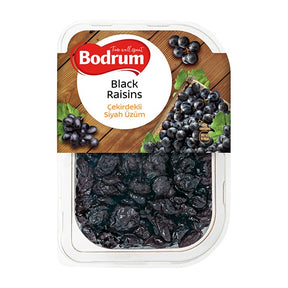 Packaged black raisins with Bodrum branding on a wooden board background