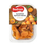 Packaged sundried apricot halves with Bodrum brand label on a wooden background