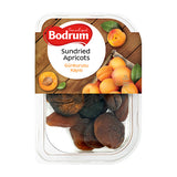 Packaged sundried apricots with Bodrum brand label on a wooden background