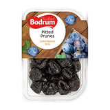 Packaged pitted prunes with Bodrum brand label on a wooden background
