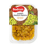 Packaging of Bodrum Golden Medium Raisins with a wooden background and green grapes.