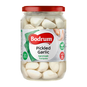 Jar of Bodrum pickled garlic on a white background