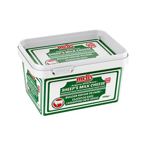Bucket of Melis sheep's milk cheese on a white background