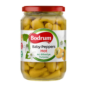 Jar of Bodrum baby peppers with a red lid on a white background