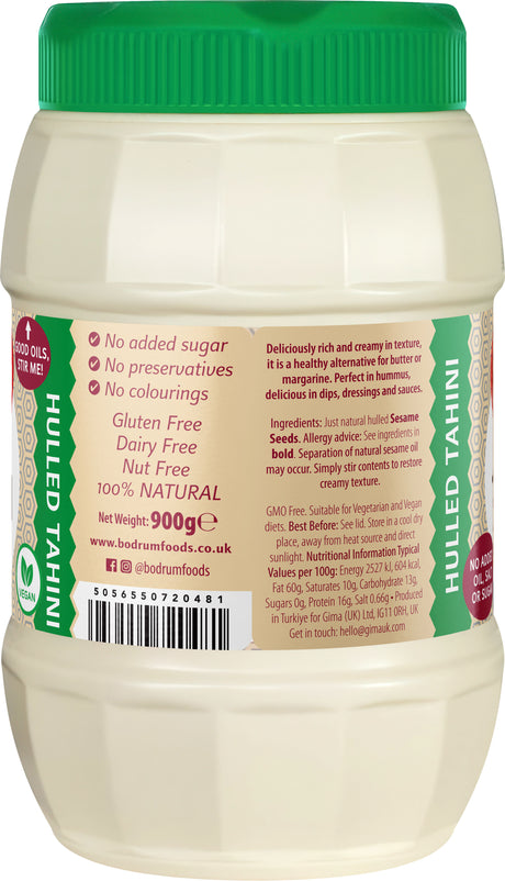 Jar of hulled tahini with green lid and label