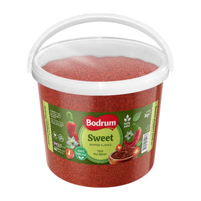 Bucket of Bodrum Sweet Pepper Flakes with a white handle on a white background