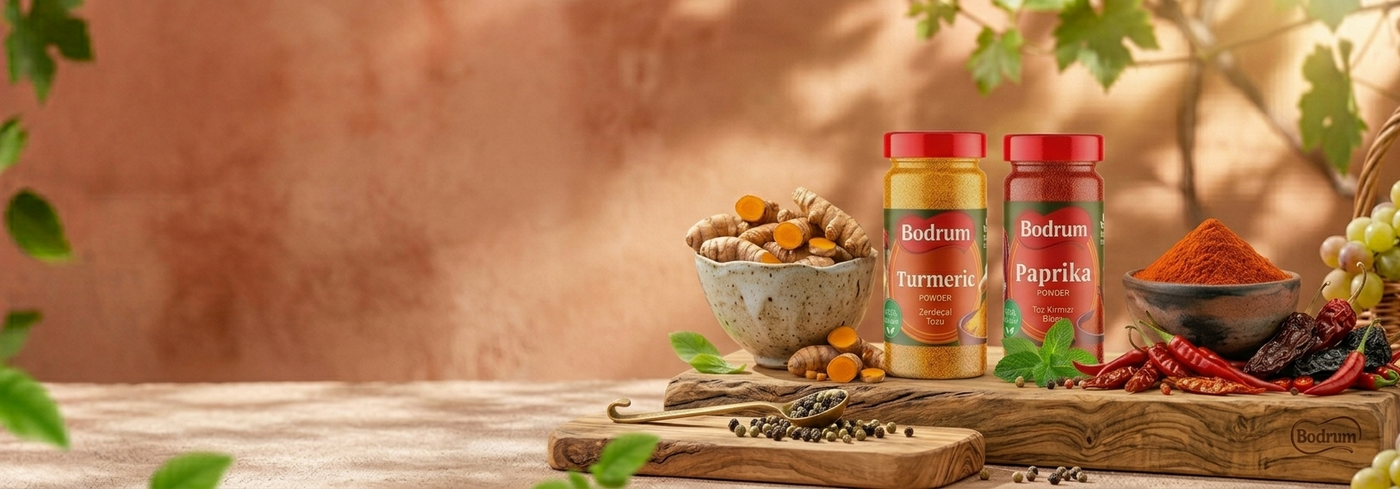 Two bottles of Bodum coffee and tea with spices and fruits on a wooden table.